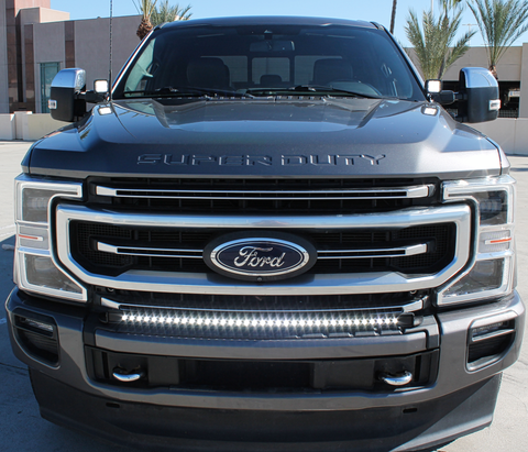 2021 gray ford super duty with white LED light bar on the bumper and white light ditch lights