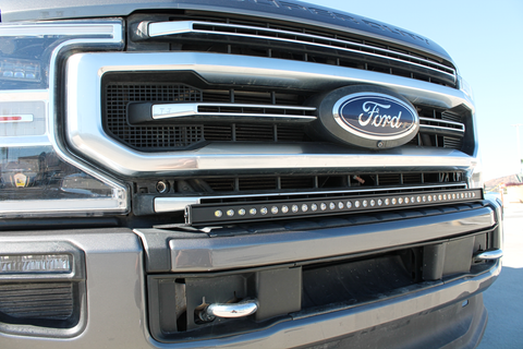 close up view 2021 gray ford super duty with LED light bar on the bumper