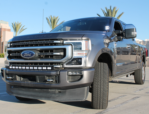 grey 2021 ford super duty with LED light bar on top of the bumper white color and white ditch lights