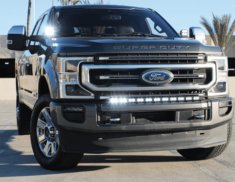 gray 2021 ford super duty ditch lights and white light bar on top of bumper