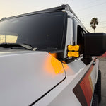 Land Cruiser ditch lights PRO for 2024+ on white Toyota Land Cruiser with amber DRL backglow and dual-color LEDs