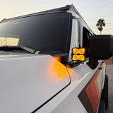 Land Cruiser ditch lights PRO for 2024+ on white Toyota Land Cruiser with amber DRL backglow and dual-color LEDs