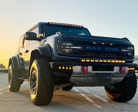 front view ford bronco raptor with amber drl led light bar on bumper and roof plus fog lights