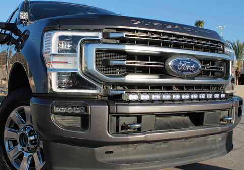 gray 2020 ford super duty with light bar on top of bumper and ditch lights