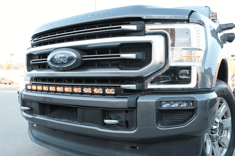 gray 2021 ford super duty with amber color ditch lights and light bar