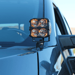 Ford Super Duty ditch lights shown on a rugged pickup, dual amber LEDs mounted on the hood for off-road visibility