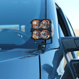 Ford Super Duty ditch lights shown on a rugged pickup, dual amber LEDs mounted on the hood for off-road visibility