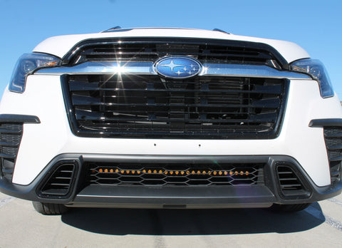 2023 white subaru ascent with amber drl light bar behind grille