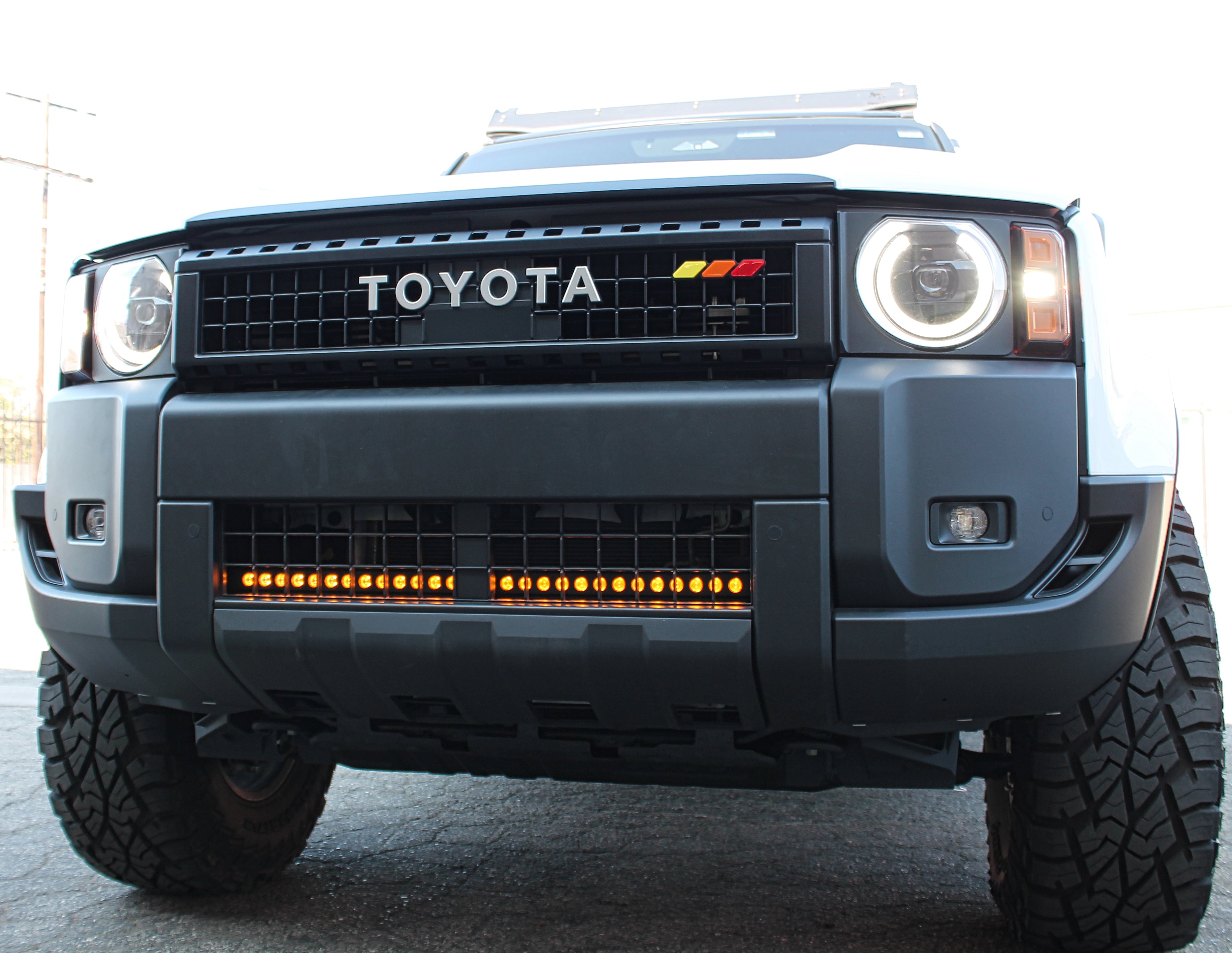 Land Cruiser lightbar installed behind the lower grille on 2024+ Toyota Land Cruiser (1958 and 200 Series); front view showing LED lightbar under bumper