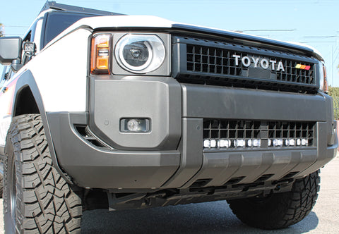 white toyota land cruiser with light bar behind the grille for off roading