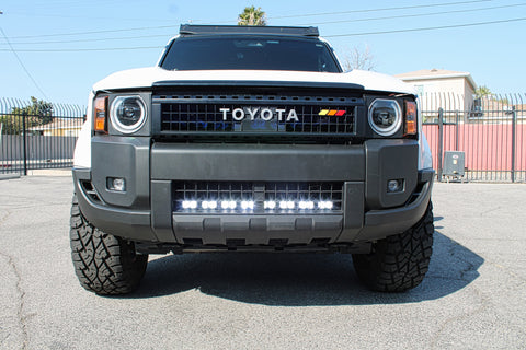 white toyota land cruiser with light bar behind the grille for off roading