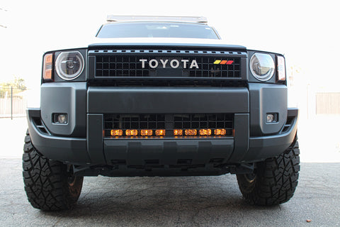 white toyota land cruiser with light bar behind the grille for off roading