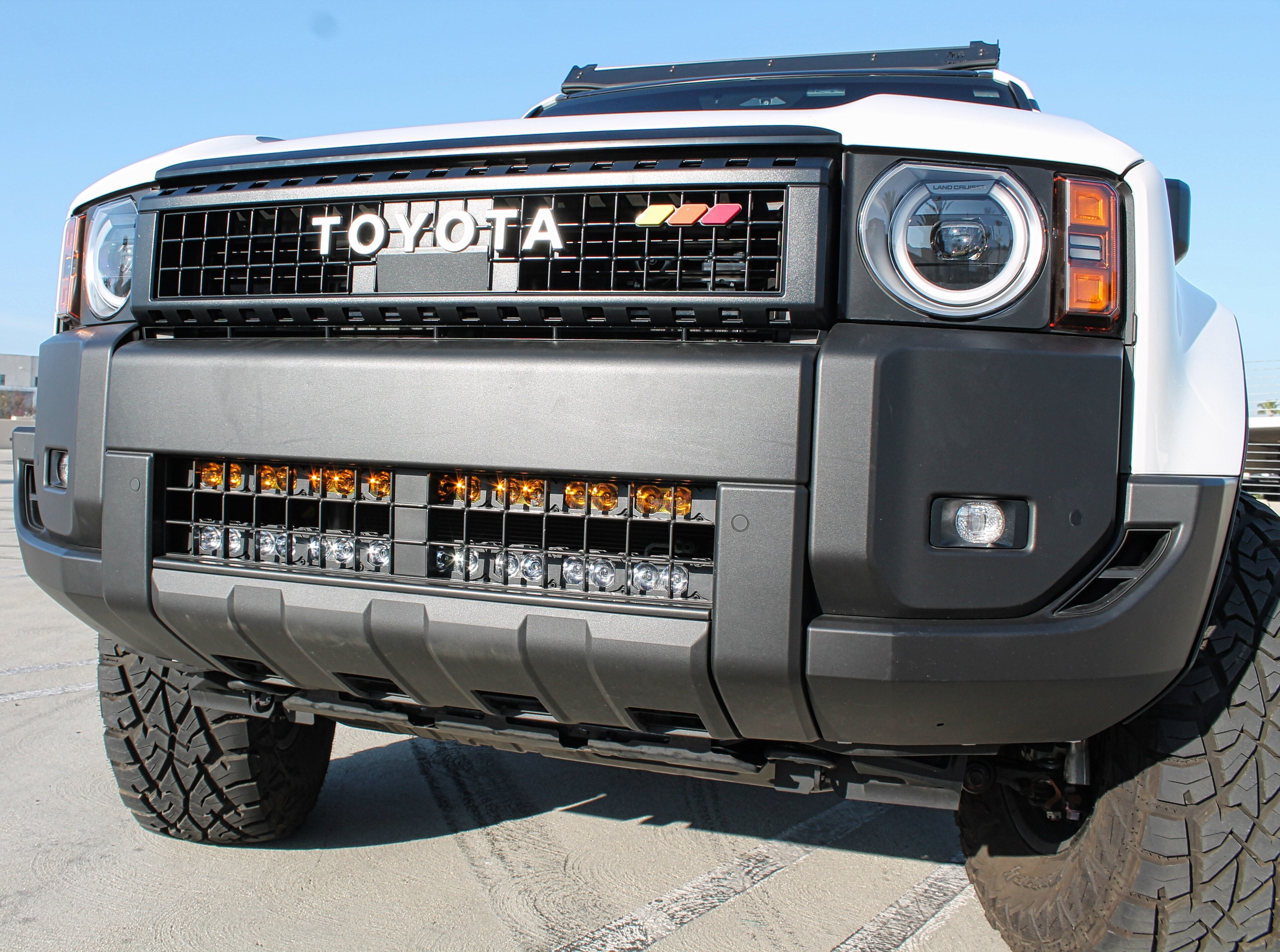 Land Cruiser ditch lights PRO for 2024+ on Toyota Land Cruiser front view with amber DRL glow