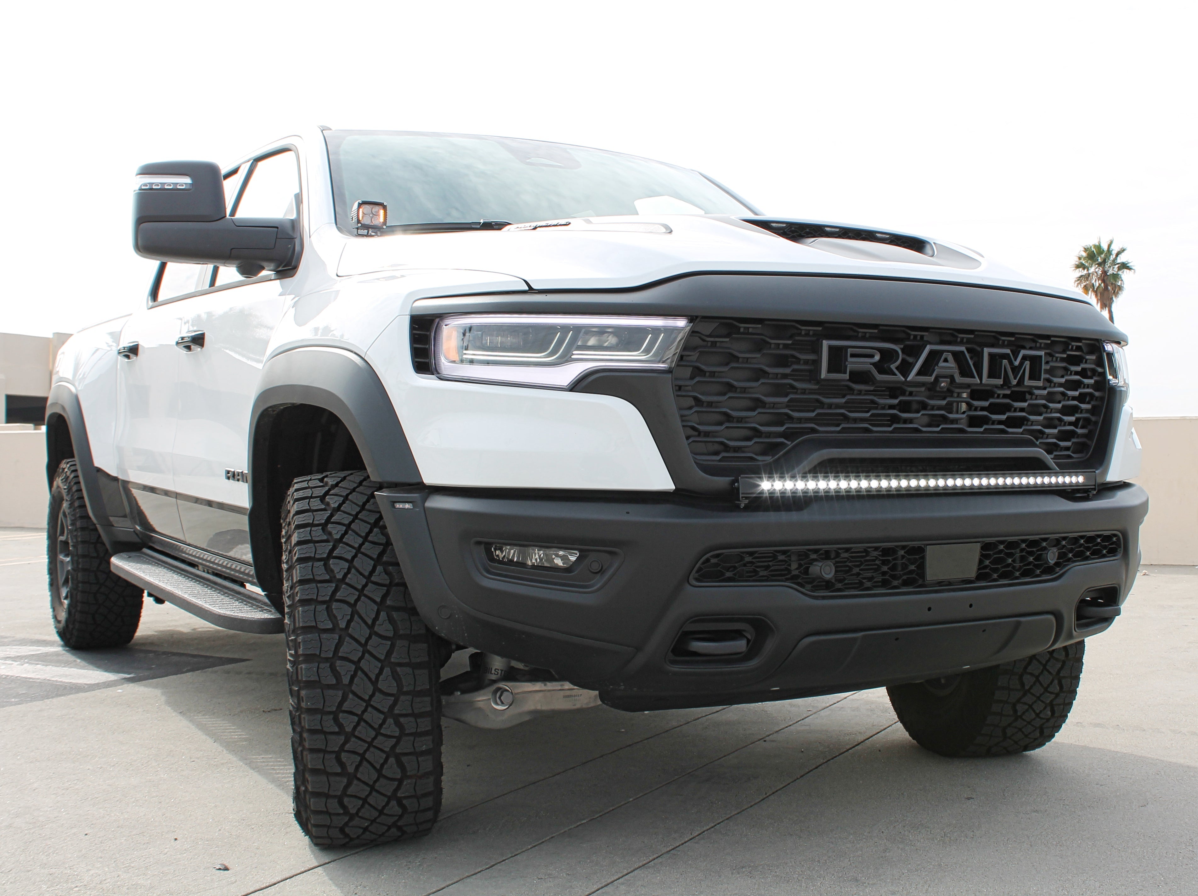 RAM RHO Lightbar on 2025+ RAM 1500 RHO, slim curved light bar integrated with factory bumper—RAM RHO Lightbar