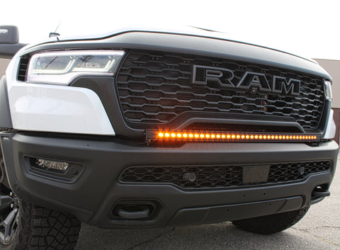 front view white ram rho with light bar on top of bumper for off roading