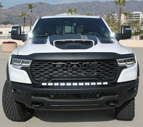 white ram rho with ditch lights, fog lights and light bar for off roading