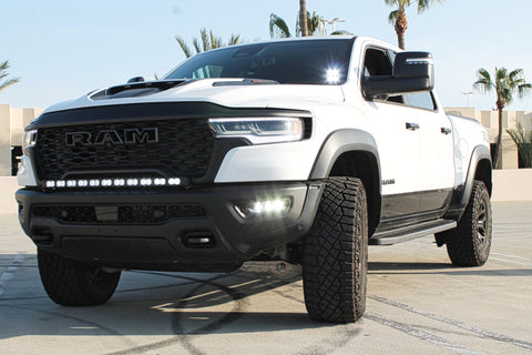 white ram rho with ditch lights, fog lights and light bar for off roading