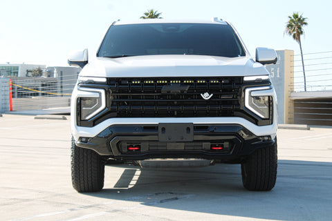 white 2025 chevrolet tahoe with light bar behind the grille for off roading