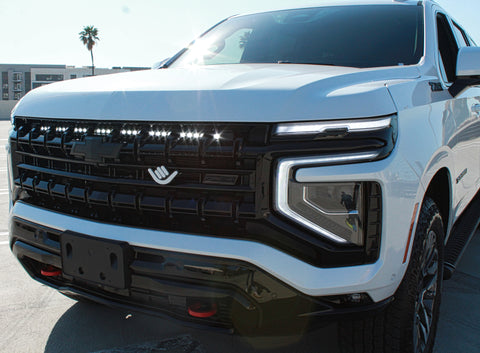 white 2025 chevrolet tahoe with light bar behind the grille for off roading