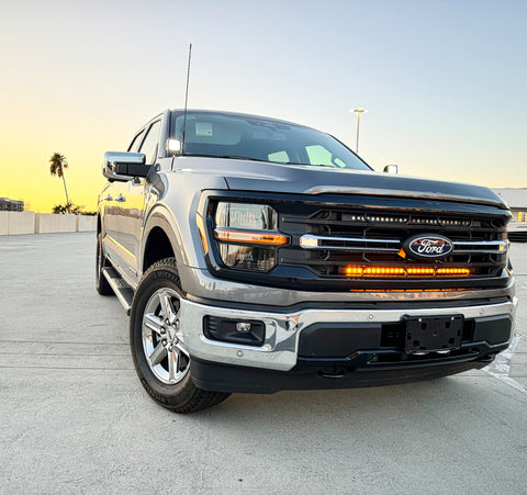 gray 2024 ford f150 with 2 led light bars behind the grille for off roading