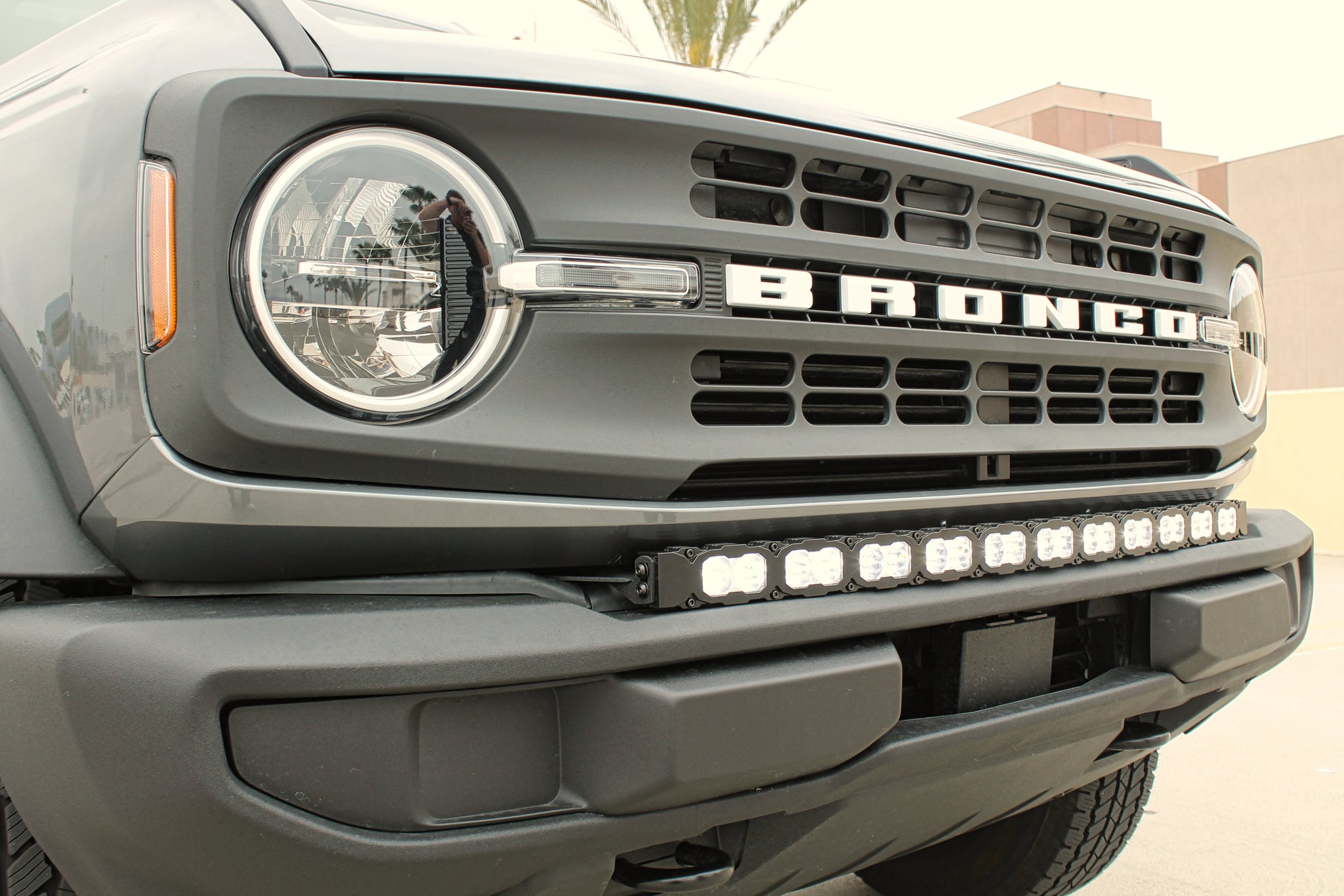 Gray 2021 ford bronco with standard bumper and 40 inch PRO light bar for off roading. 