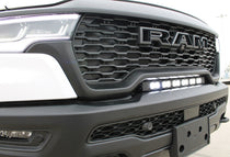 RAM RHO light bar PRO 23in curved LED installed between grille and bumper on 2025 RAM 1500 RHO front view