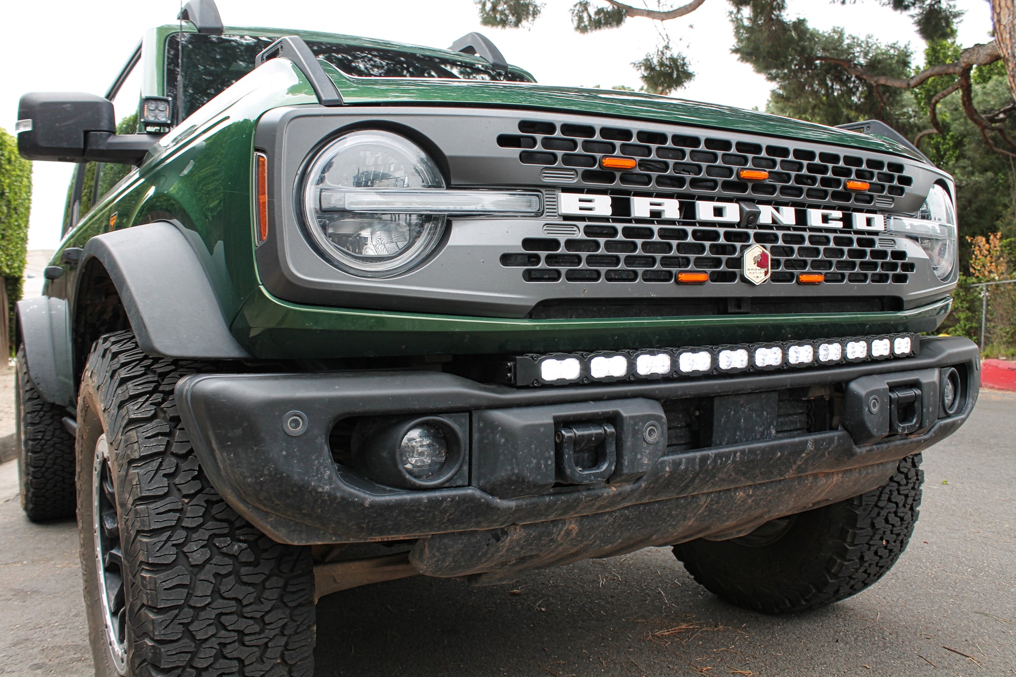 green 2021 bronco capable bumper with white led light bar installed on top for off roading