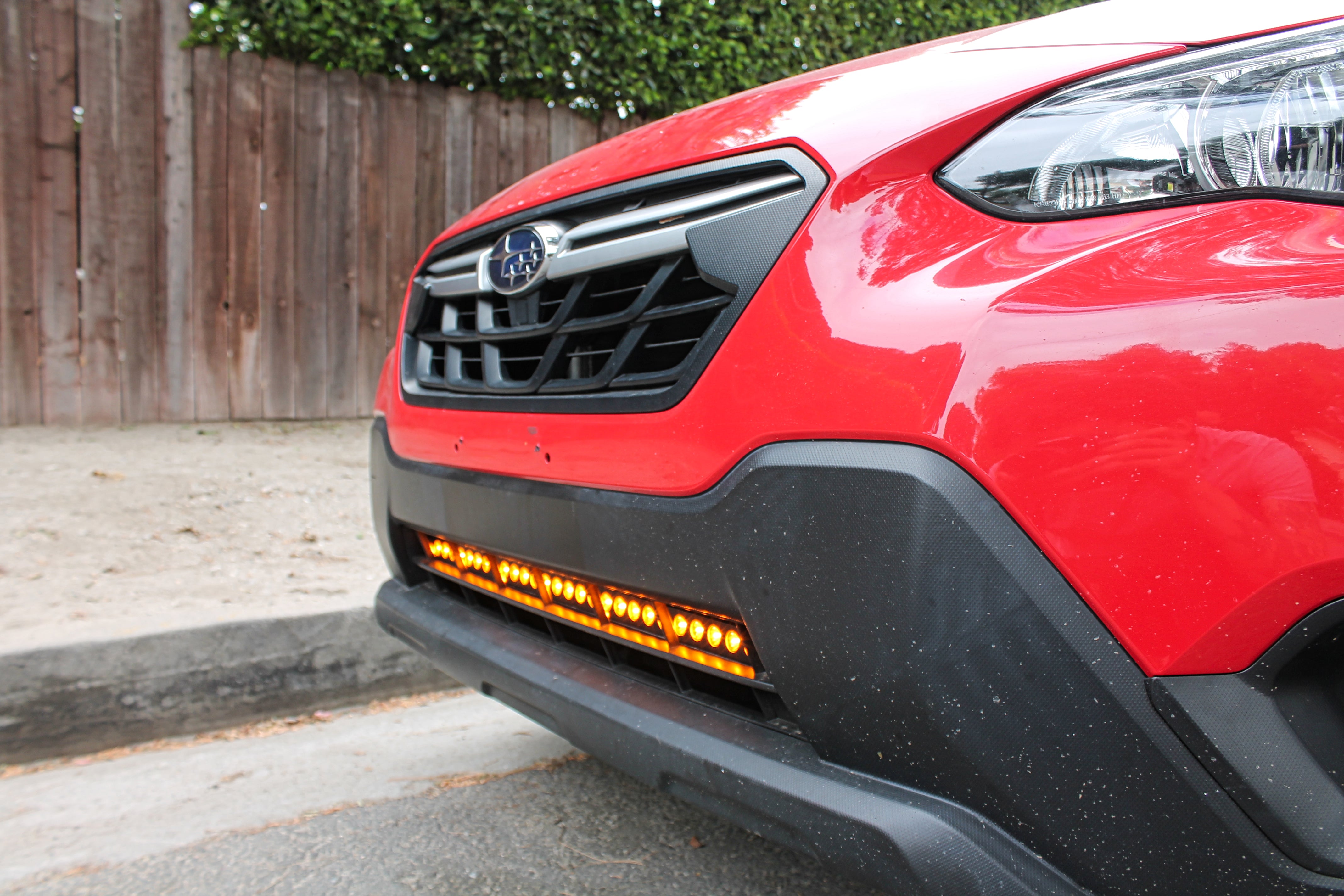red 2018 subaru crosstrek gen 2 with light bar in lower grille for off roading