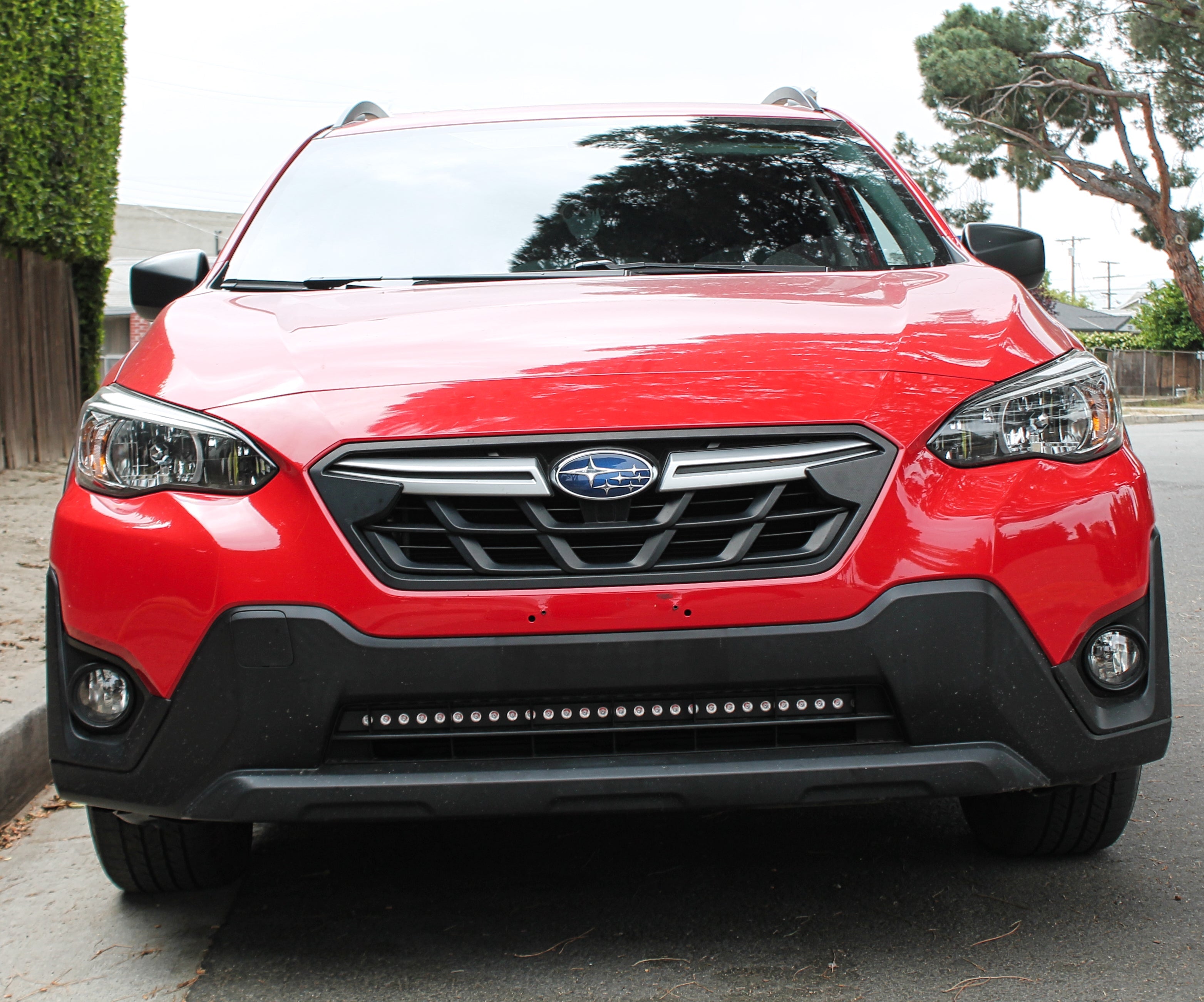 red 2023 subaru crosstrek gen 2 with light bar for off roading installed lower grille