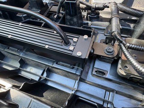 behind grille of new toyota tacoma 2024 showing metal bracket for led light bars 