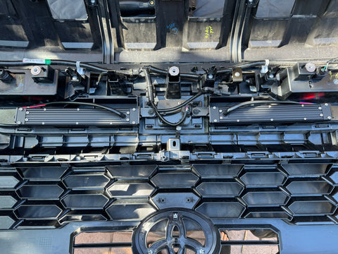 behind grille new 2024 toyota tacoma showing light bars