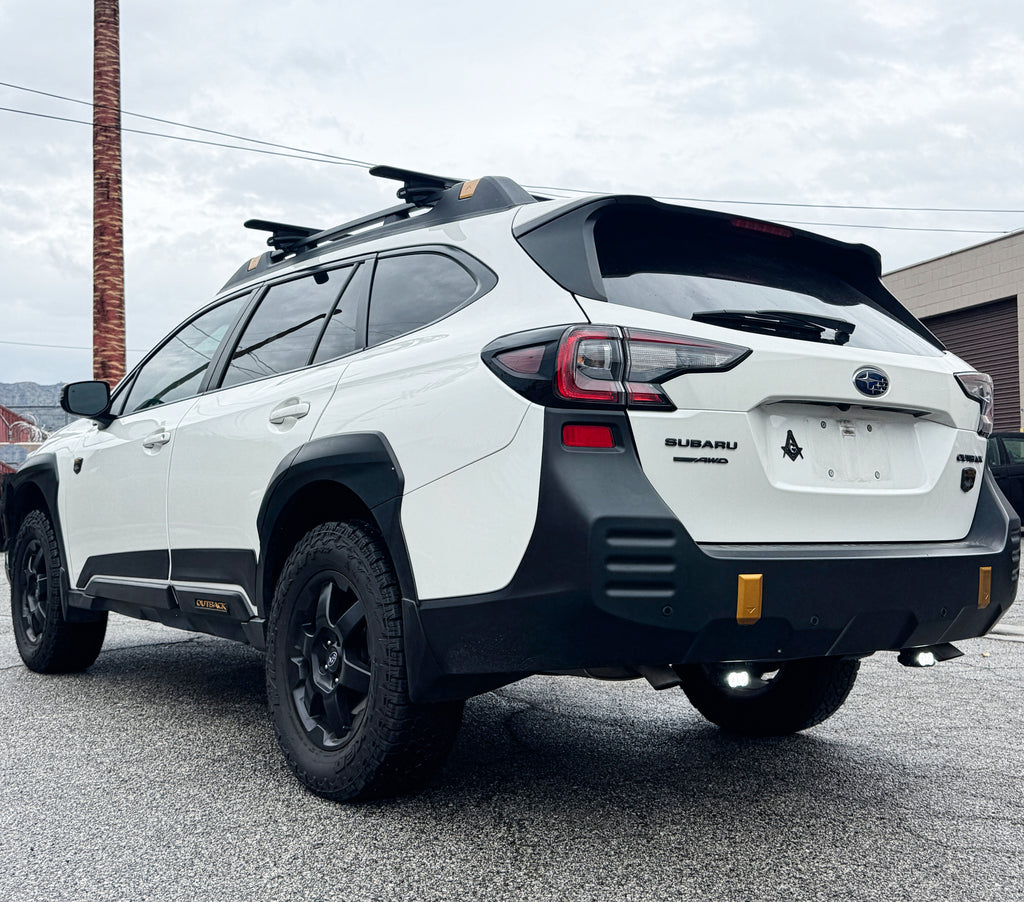 white 2021 subaru outback with bright reverse lights for off roading