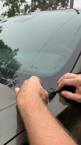 Hands installing hood mount for 2024 Ford Ranger Raptor, demonstrating accessory placement on vehicle.