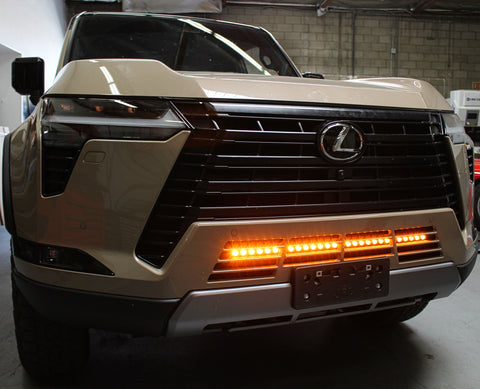 Lexus GX550 lightbar on 2024+ GX550 front grille shot, slim 30in LED light bar mounted behind lower grille, not affecting radiator cooling