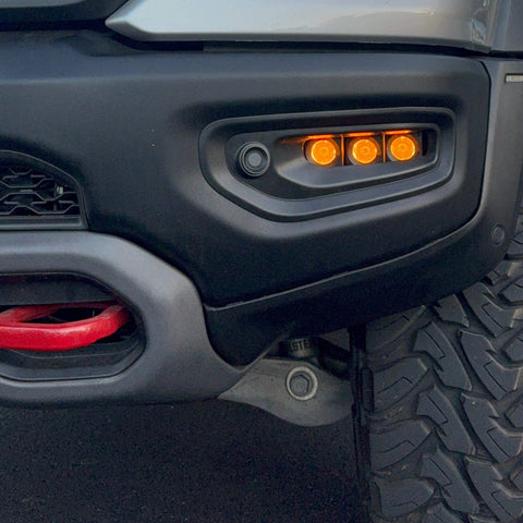 RAM Rebel fog light kit 2019-2024 with three amber LED pods mounted in front bumper