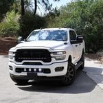 2025+ RAM 2500 Light kit lower grille pods installed on white RAM 2500 truck front view on road