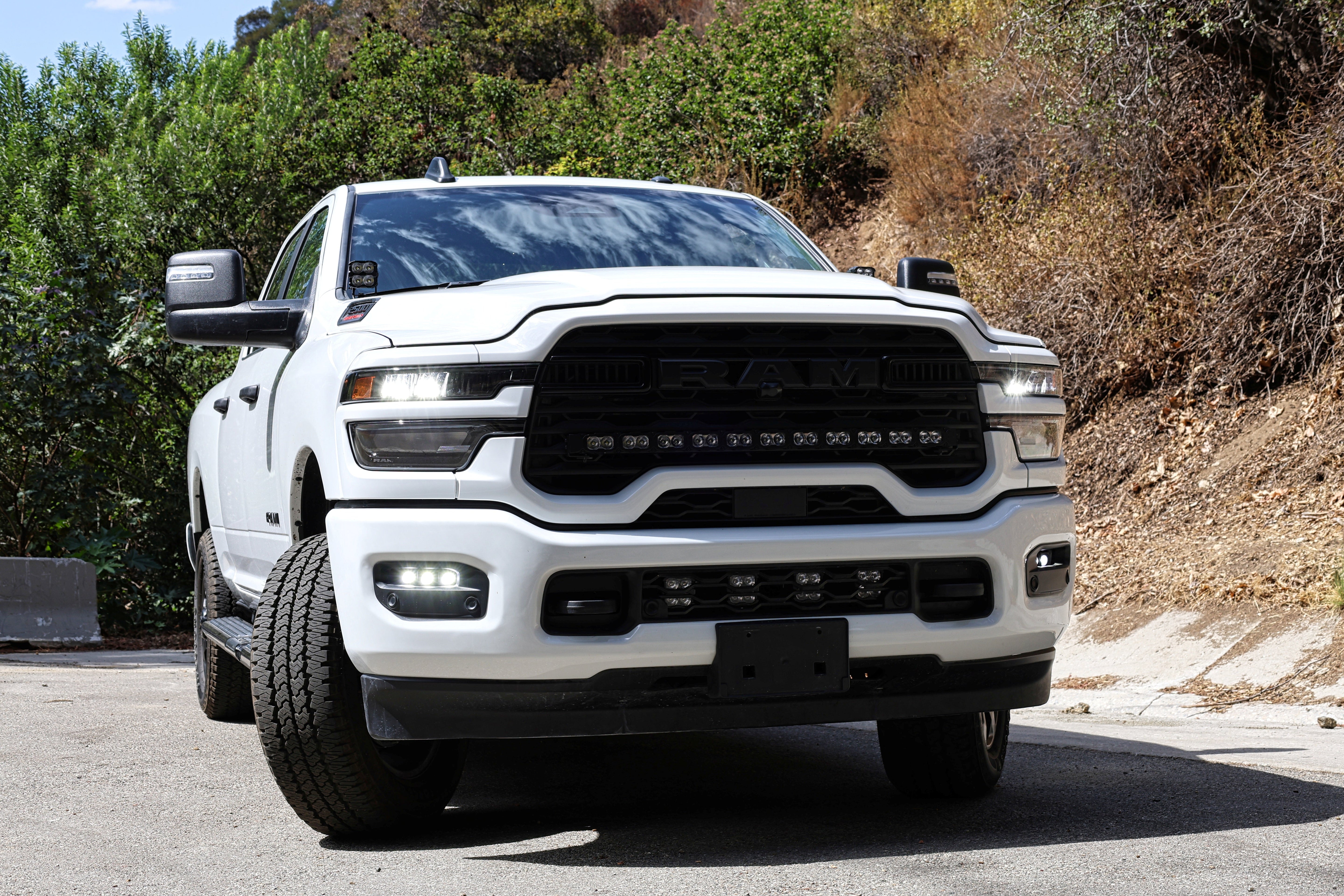 2025+ RAM 2500 & 3500 Ditch Lights PRO dual color white LED with amber DRL installed on white RAM truck front view