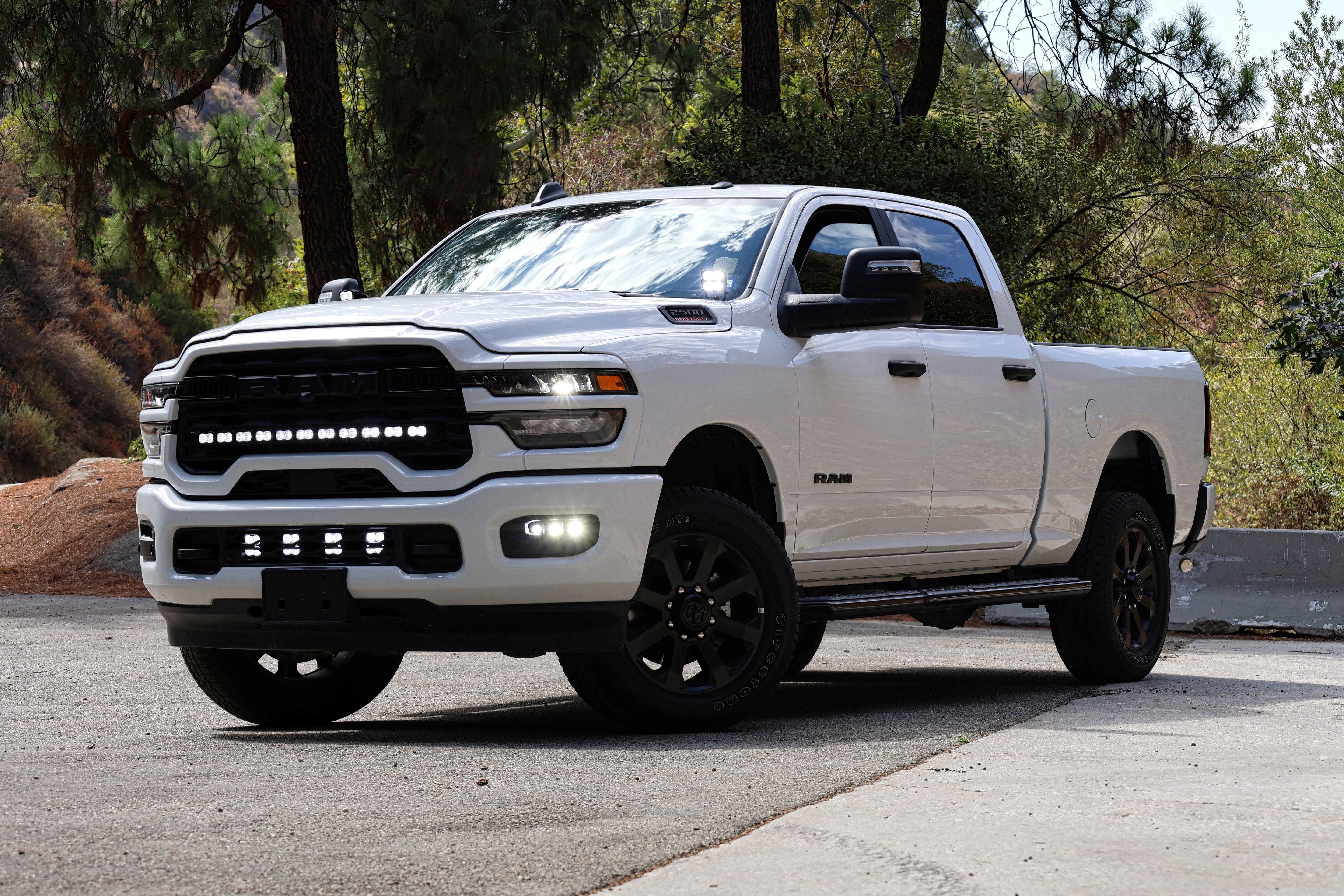 RAM 2500 Fog Light Kit installed on white RAM 2500 truck with upgraded LED fog lights illuminated on front bumper