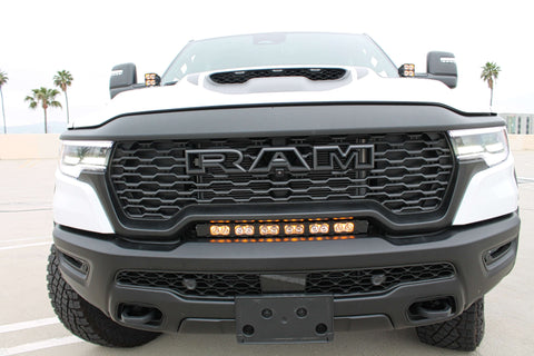 RAM RHO light bar PRO 23in curved LED installed between grille and bumper on 2025 RAM 1500 RHO truck front view