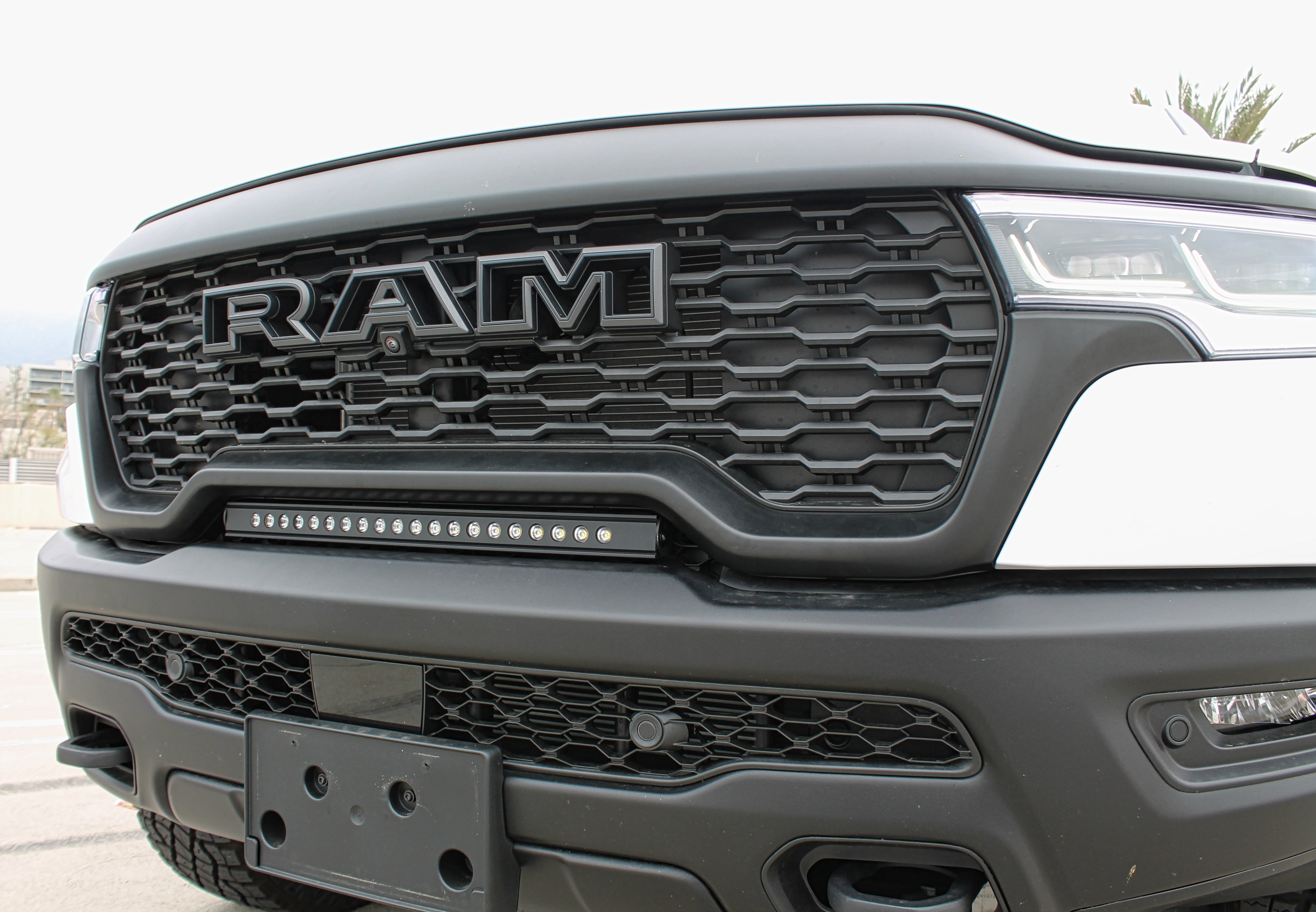 RAM RHO lightbar installed on 2025+ RAM 1500 Rebel between grille and bumper for a slim, built-in look