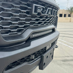 RAM RHO lightbar on 2025 RAM 1500 Rebel, slim curved light bar installed between grille and bumper with black powder-coated bracket