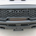 RAM RHO lightbar on 2025+ RAM 1500 Rebel with slim curved installation between grille and bumper, metal black powder-coated bracket, built-in sleek look