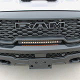 RAM RHO lightbar on 2025+ RAM 1500 Rebel with slim curved installation between grille and bumper, metal black powder-coated bracket, built-in sleek look