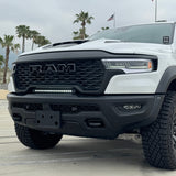 RAM RHO lightbar fits 2025 2026 RAM 1500 Rebel with slim curved profile between grille and bumper; RAM RHO lightbar for 23in slim height, powder coated black bracket