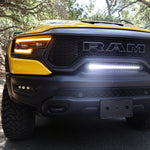 RAM TRX Light bar slim 23in installed in factory grille opening on yellow 2021-2024 RAM 1500 TRX front view