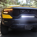 RAM TRX Light bar slim 23in installed in factory grille opening on yellow 2021-2024 RAM 1500 TRX front view