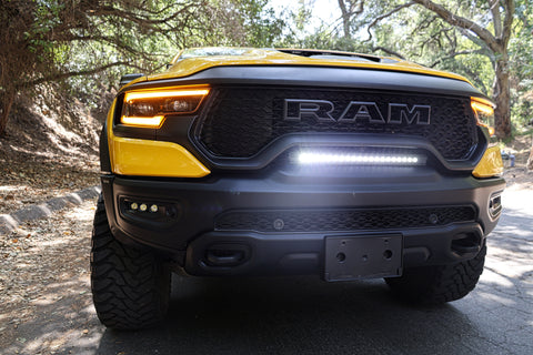 RAM TRX Light bar slim 23in installed in factory grille opening on yellow 2021-2024 RAM 1500 TRX front view