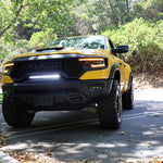 RAM TRX Light bar slim 23in curved LED in factory grille opening on yellow 2021-2024 RAM 1500 TRX front view