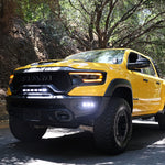 RAM TRX Lightbar 23in PRO installed on yellow RAM 1500 TRX 2021-2024 driving on forest road