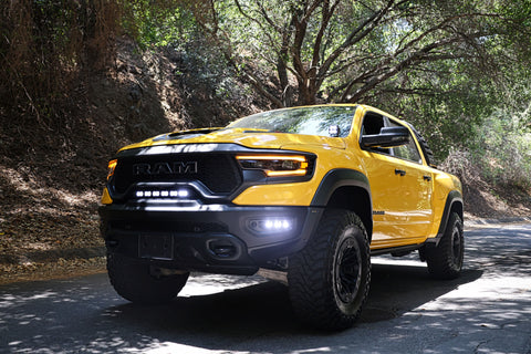 RAM TRX Lightbar 23in PRO installed on yellow RAM 1500 TRX 2021-2024 driving on forest road